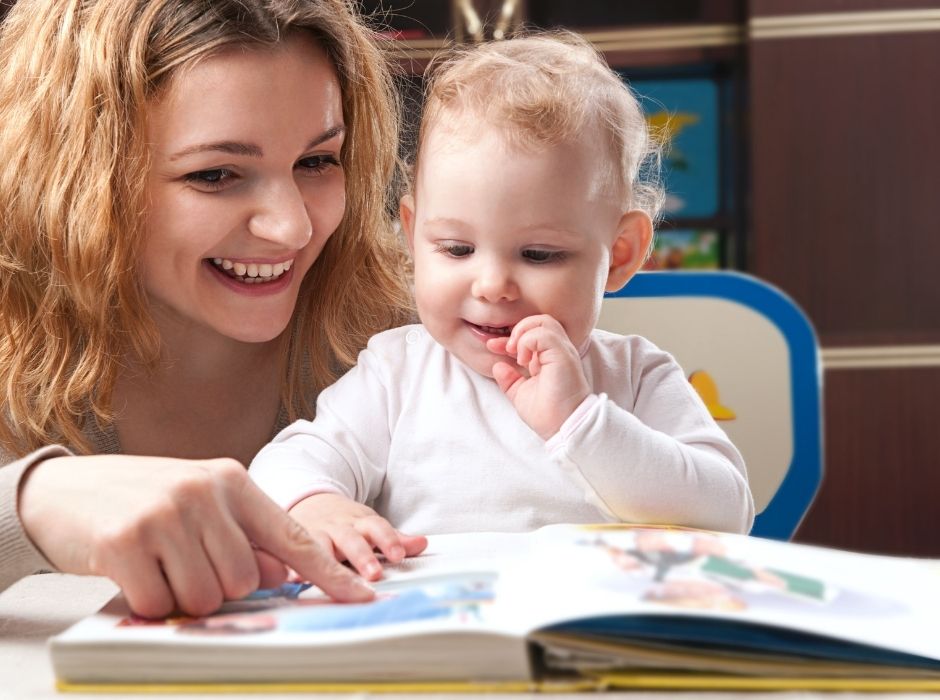 children read. a baby child with his mom reading a book