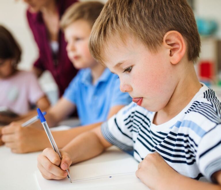 return to school. Child writing with a pen